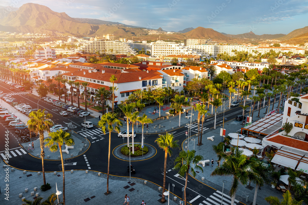 sunset cityscape of Playa de las Americas holiday resort streets in Tenerife. Canary islands, Spain