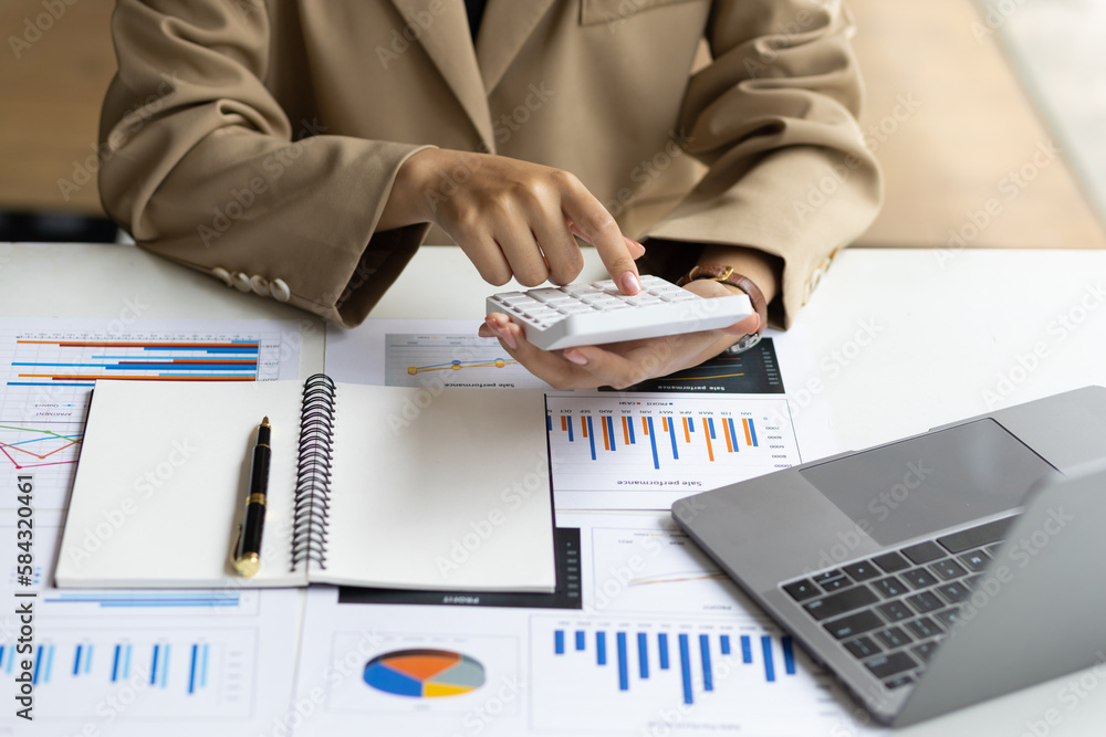 Businesswoman working with financial accounting documents in the office.