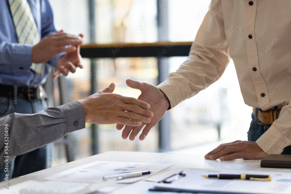 Meeting of business people, financial advisors shaking hands.