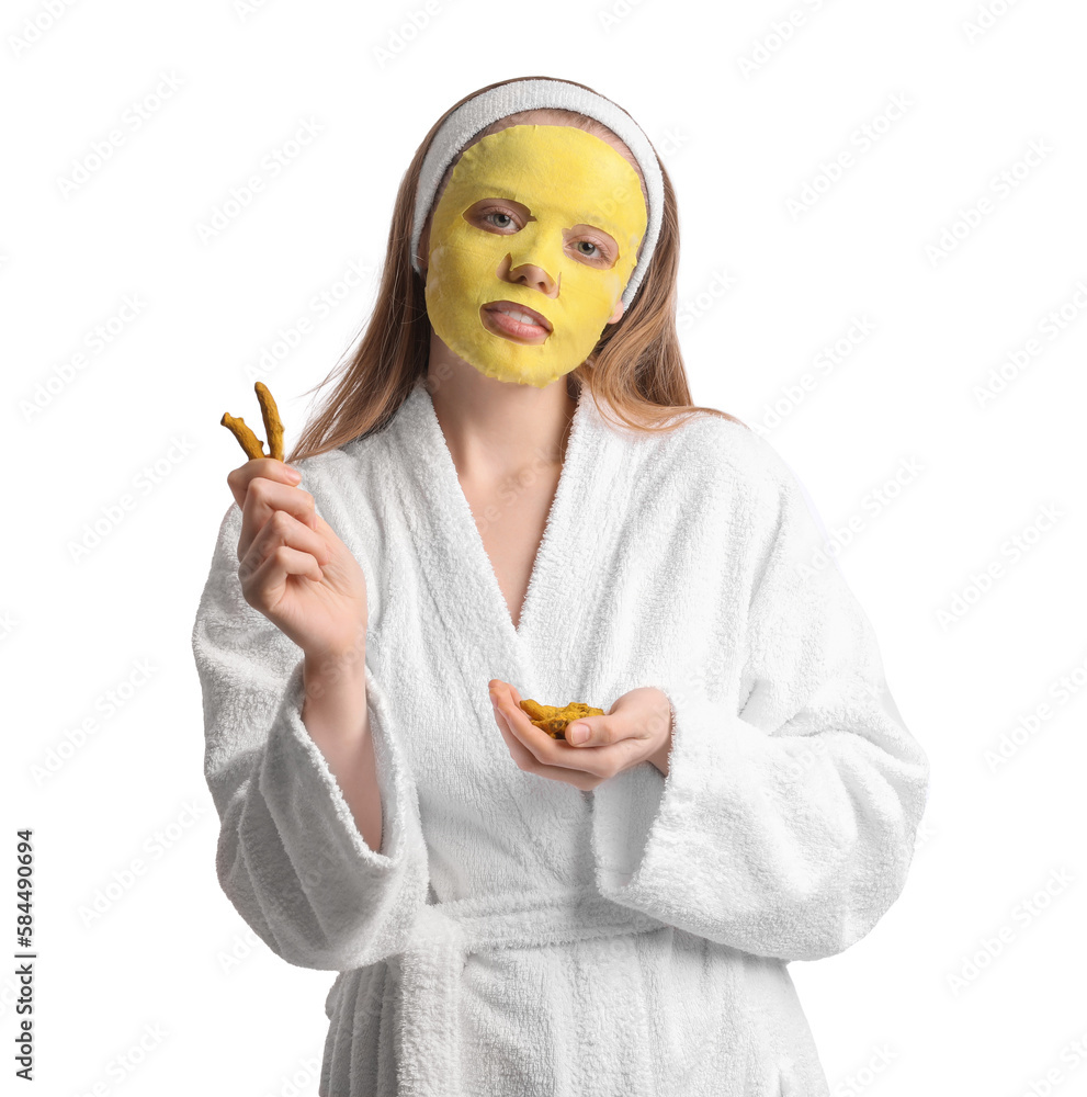 Young woman with turmeric mask and roots on white background