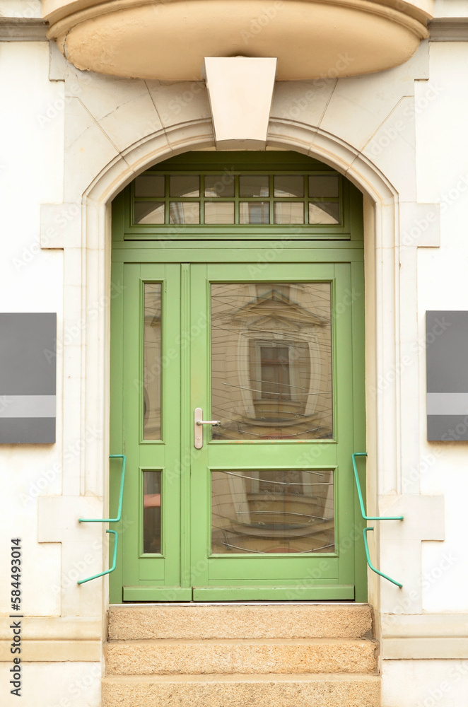 View of old building with green wooden door