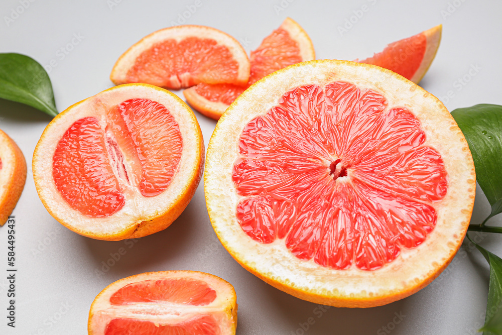 Pieces of ripe grapefruit on light background, closeup