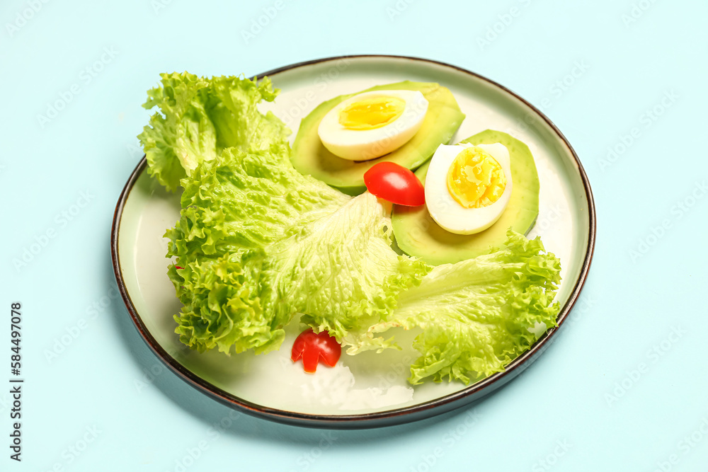 Plate with funny breakfast in shape of owl on blue background