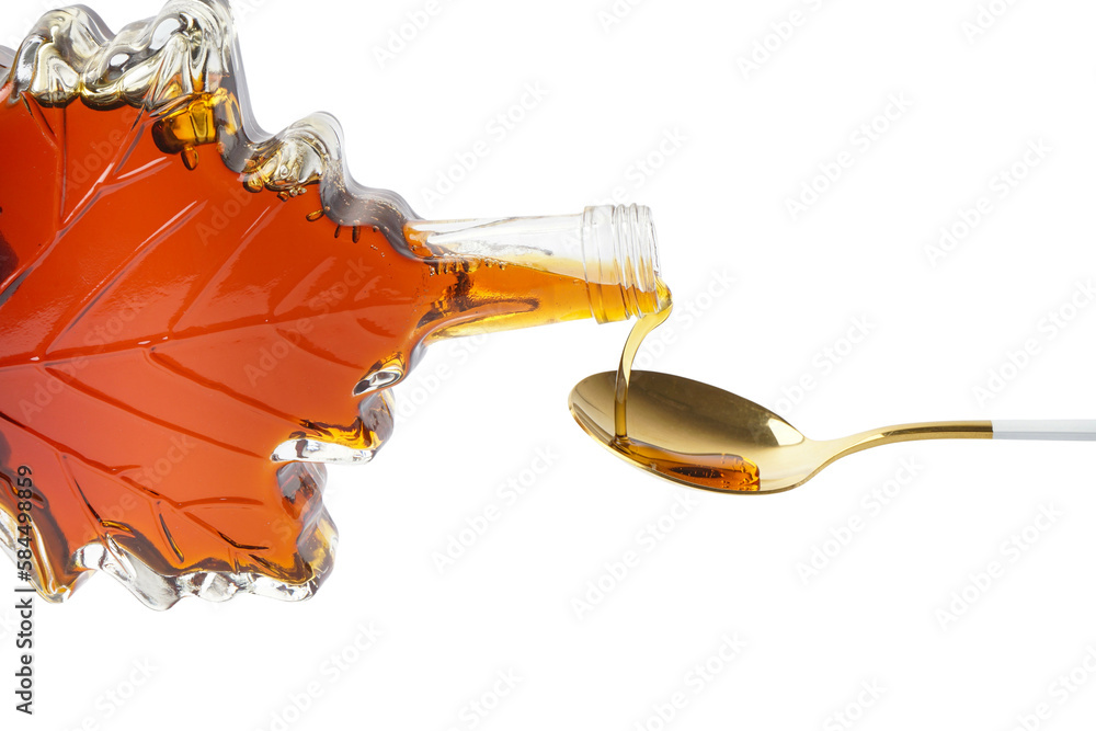 Pouring of tasty maple syrup from bottle into spoon on white background, closeup