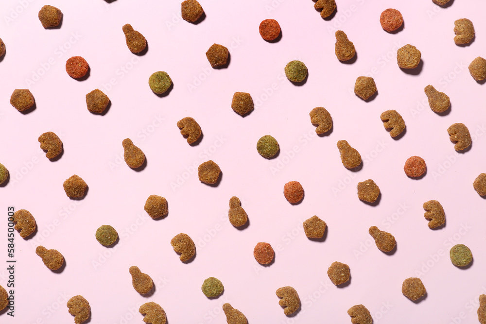 Composition with dry pet food on pink background