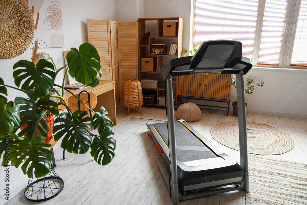 Modern treadmill in interior of modern room