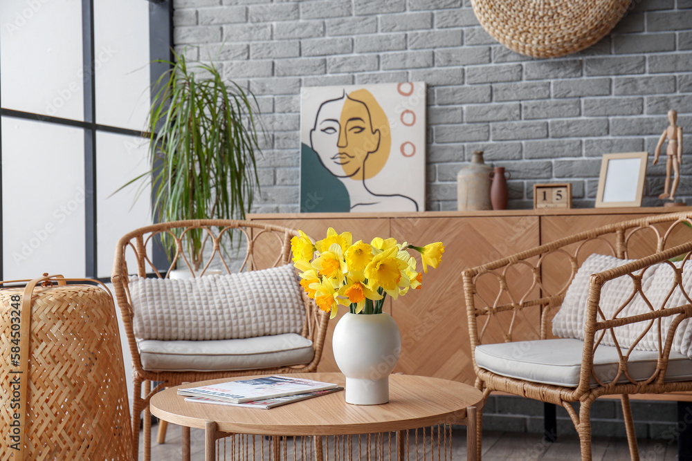 Interior of stylish living room with cozy armchairs and flower vase on coffee table