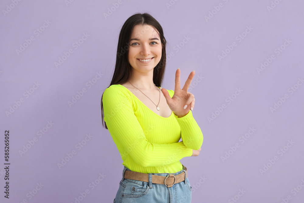 Young woman in bright shirt on lilac background