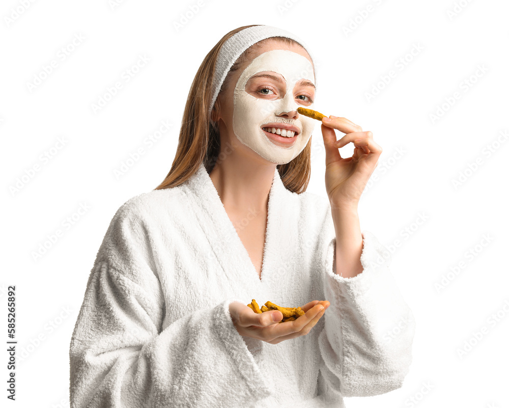 Young woman with applied turmeric mask and roots on white background