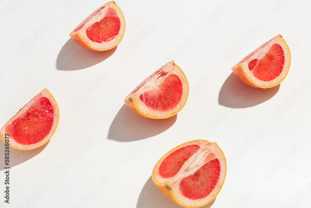 Pieces of ripe grapefruit isolated on white background