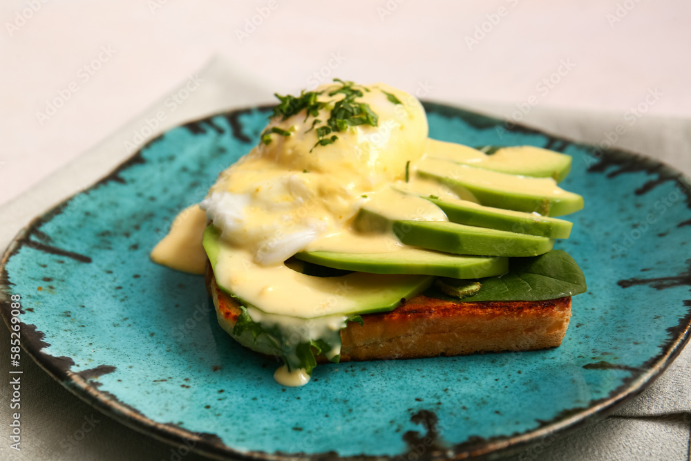 Plate with tasty egg Benedict on white table, closeup