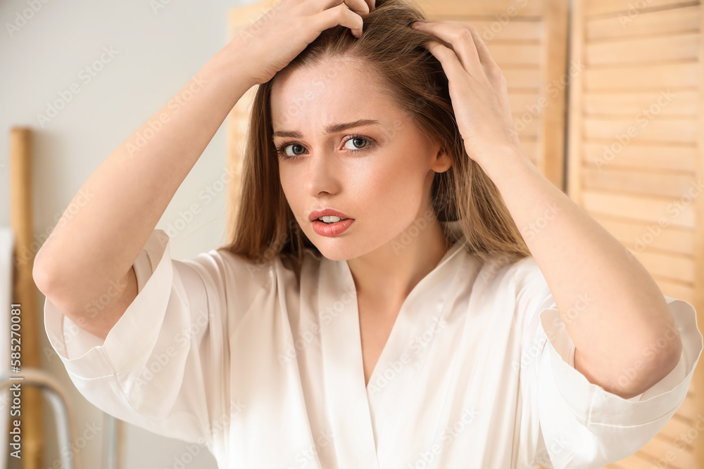 Young woman with hair loss  problem  at home