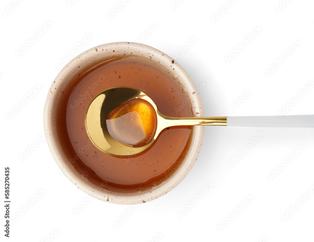 Bowl and spoon of tasty maple syrup on white background