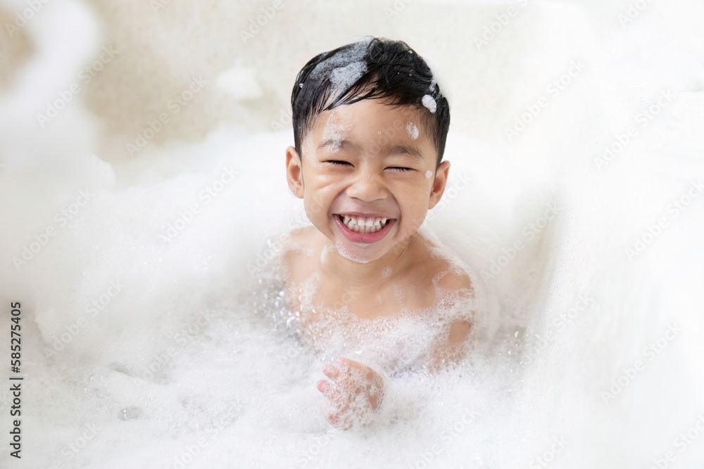 boy taking a bath in the tub take bath he plays with bubbles