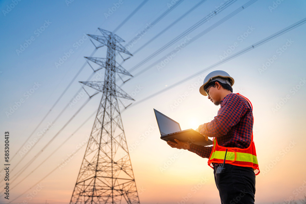 Asian electrical engineer checking position using notebook computer at power station for planning wo