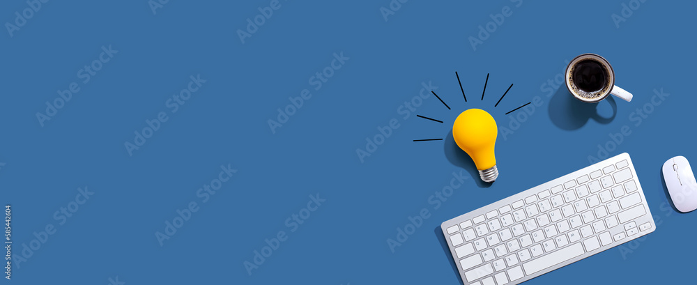 Computer keyboard with a yellow light bulb from above