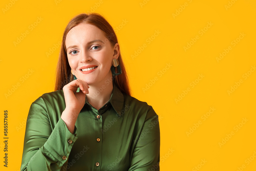 Beautiful redhead woman on yellow background