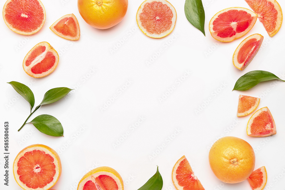 Frame made of juicy grapefruit pieces and plant leaves on white background, closeup