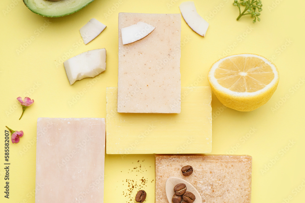 Composition with soap bars and natural ingredients on yellow background