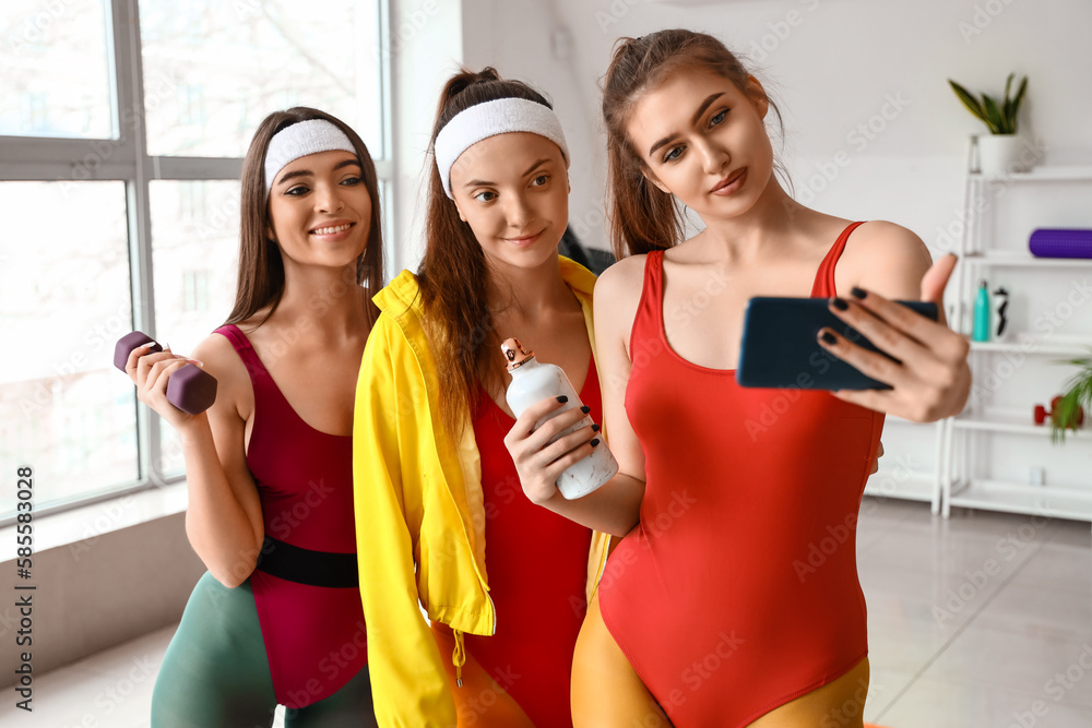 Sporty young women taking selfie in gym