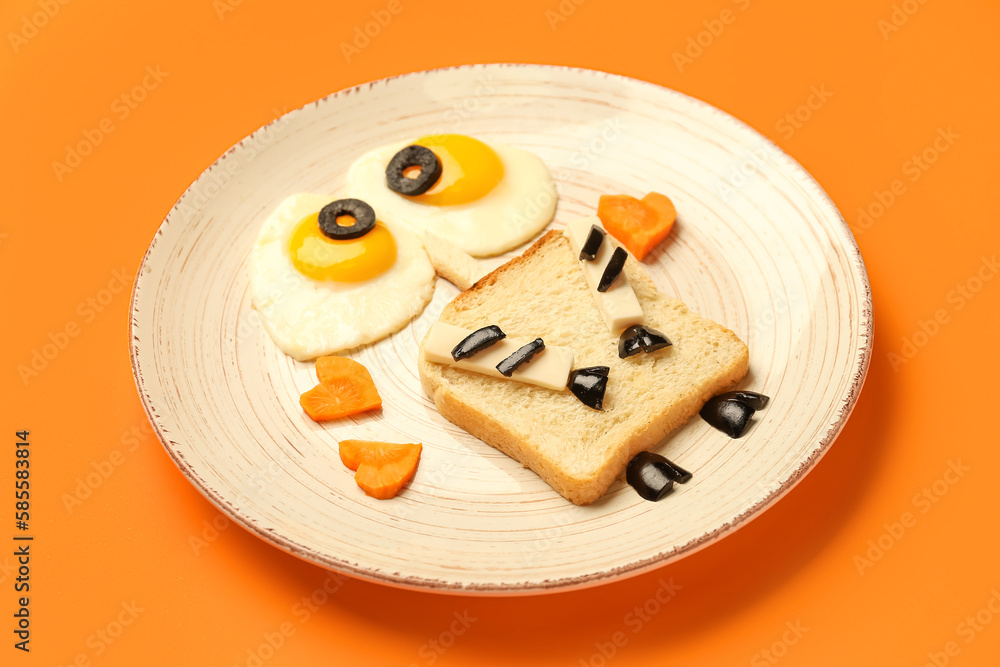 Plate with funny childrens breakfast on orange background