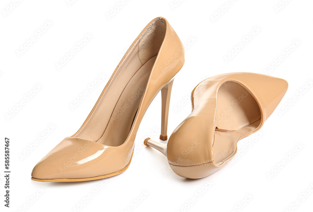 Pair of beige high heeled shoes on white background