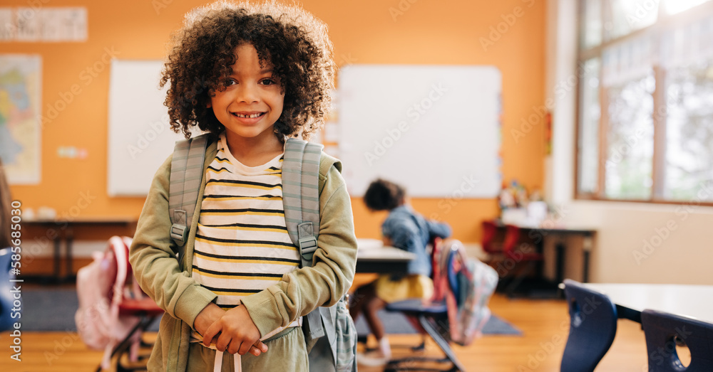 Young male student smiling and looking at camera on first day of co-ed class