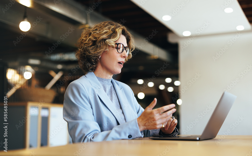 Business woman talking on a video call in a coworking office