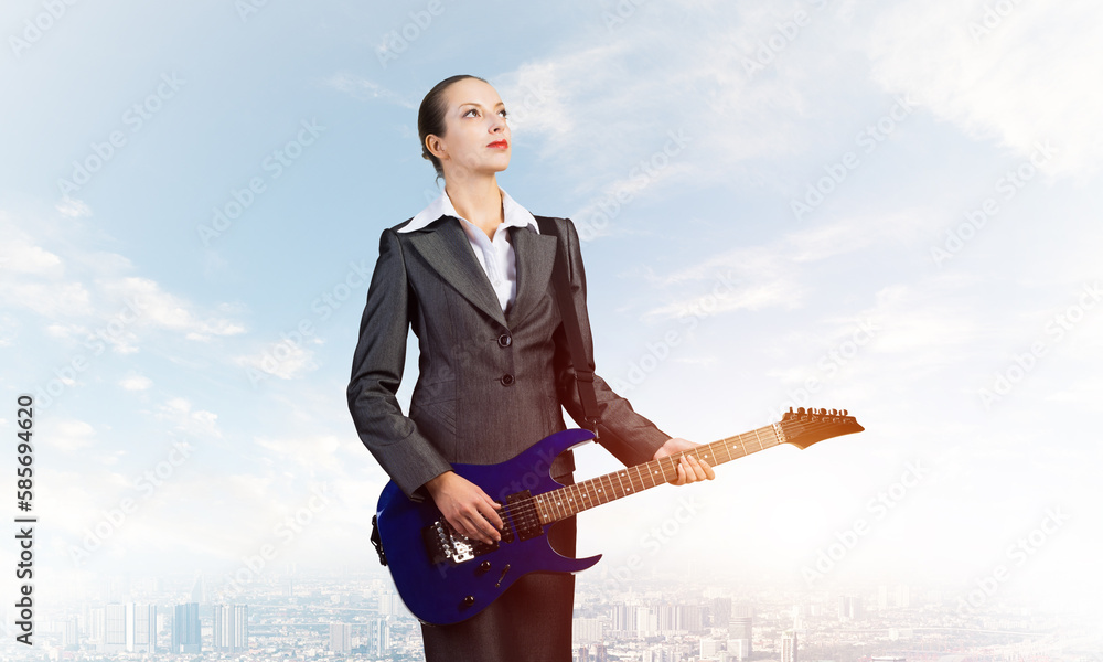 Young businesswoman with electric guitar