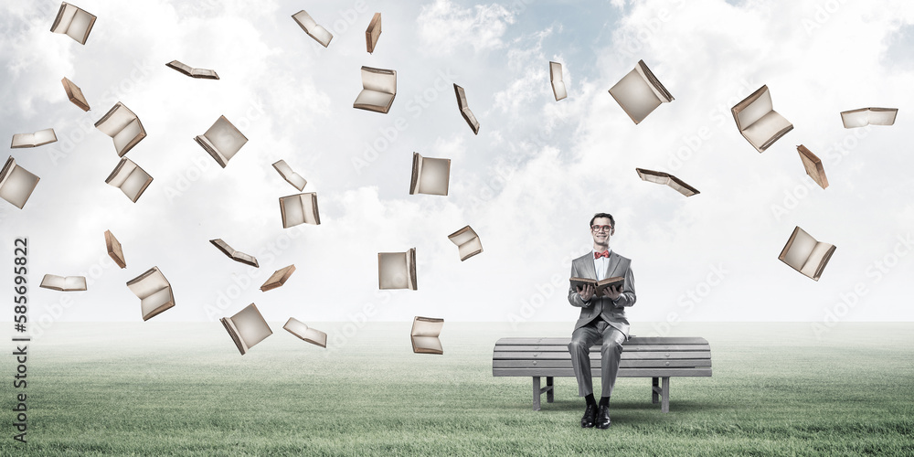 Young businessman or student studying the science and books fly around