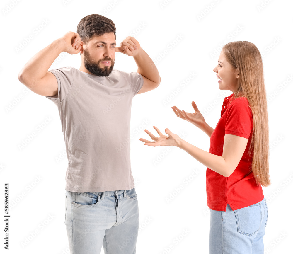 Young woman shouting at her husband on white background