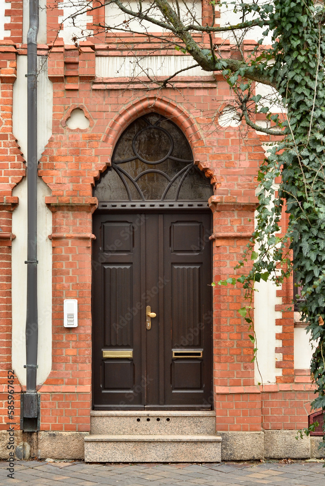 View of brick building with wooden door