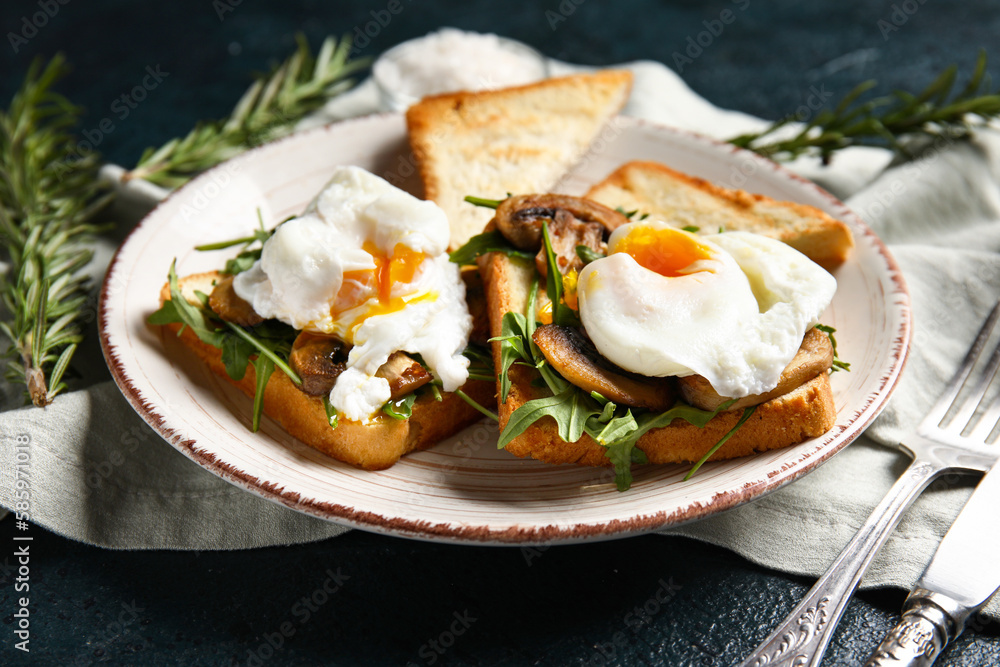 Plate with tasty eggs Benedict on black background