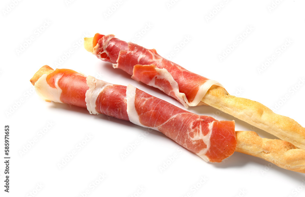 Tasty Italian Grissini with bacon on white background, closeup