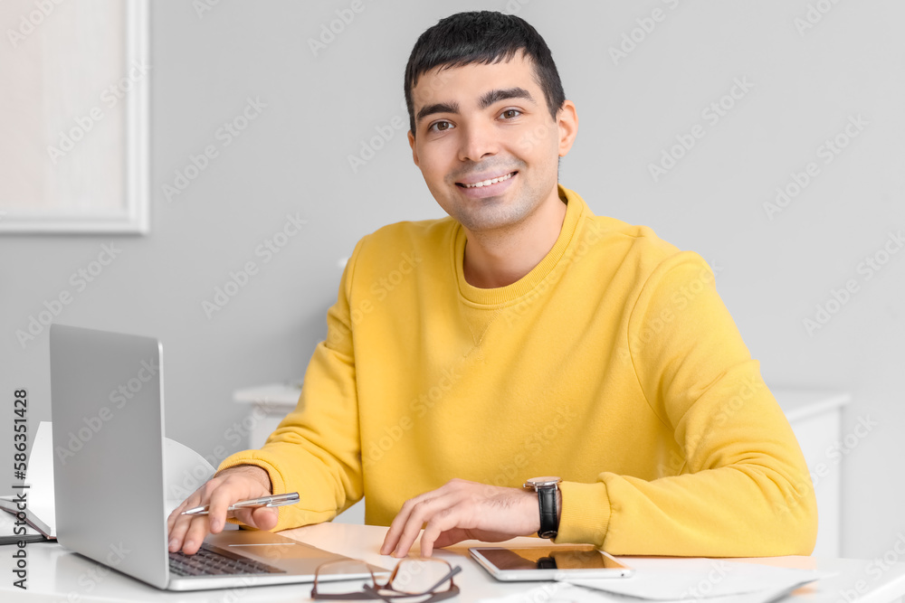 Young man working on laptop  in office