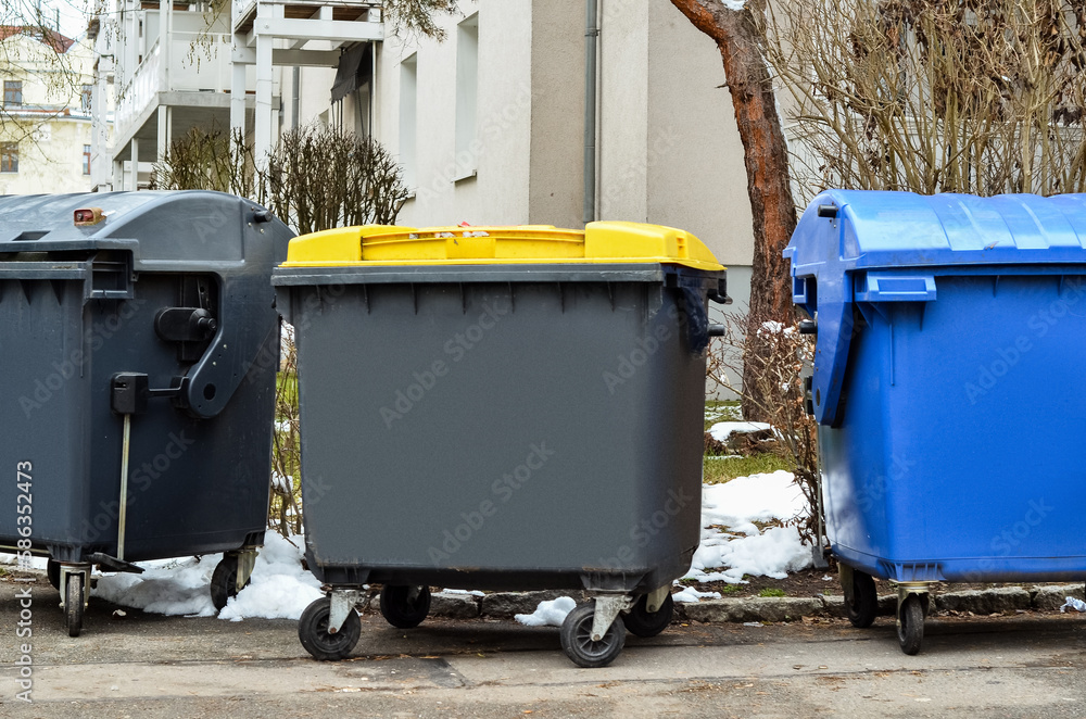 View of garbage containers in city on winter day