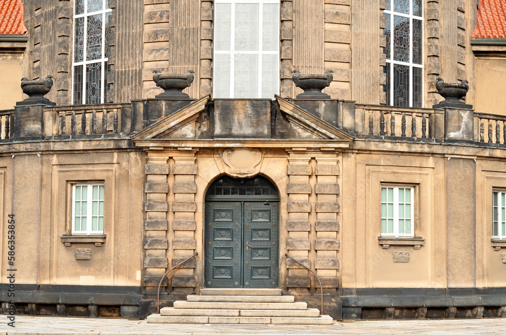 View of old building with wooden door and steps