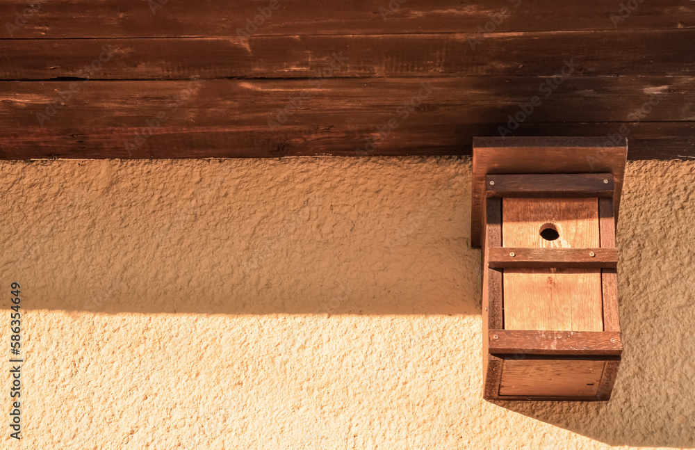 View of wooden bird house on building outdoors