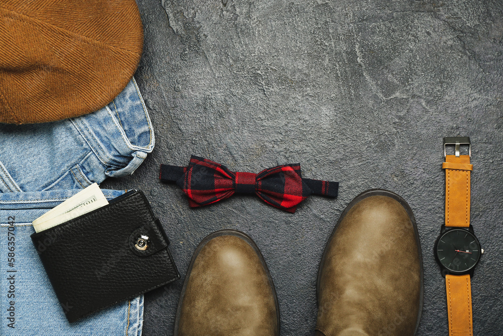 Composition with male shoes, clothes and accessories on dark background