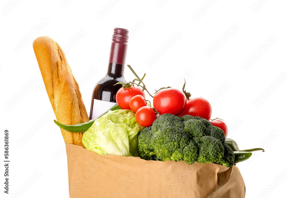 Paper bag with vegetables, bread and wine bottle on white background