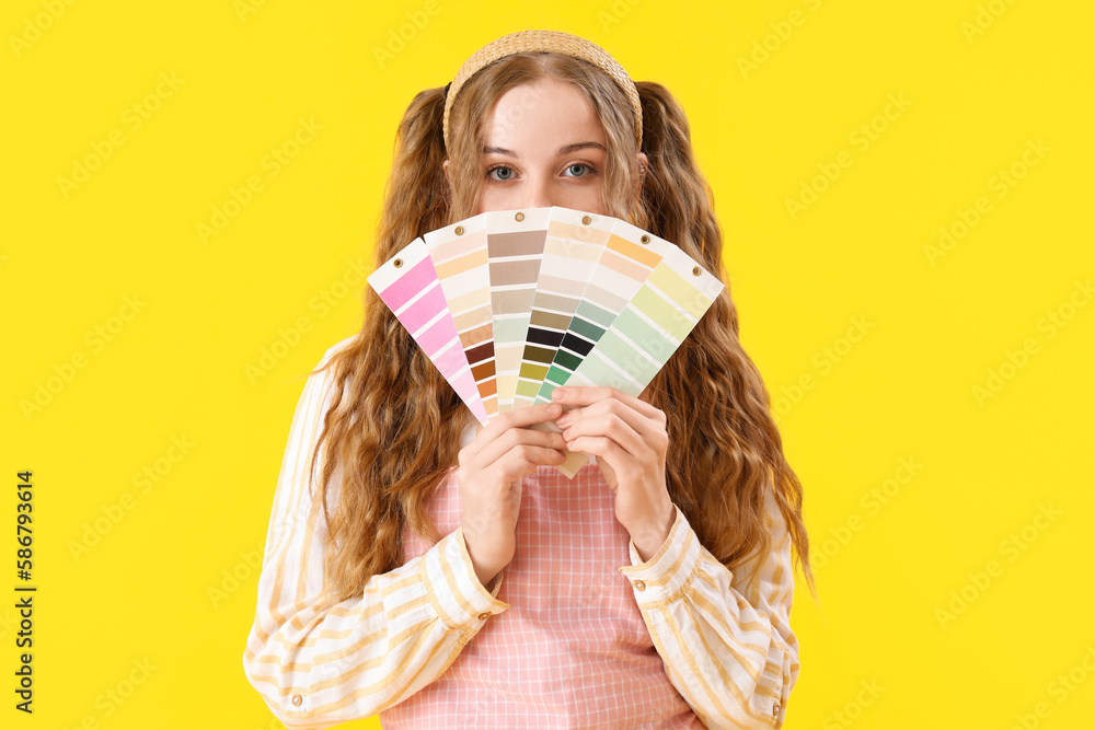 Female artist with paint color palettes on yellow background