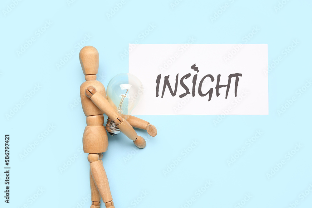 Paper with word INSIGHT, wooden mannequin and light bulb on blue background