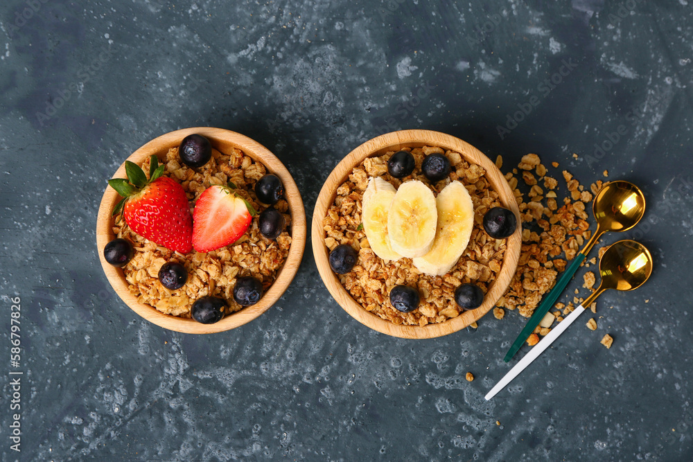 Bowls of tasty granola on blue background