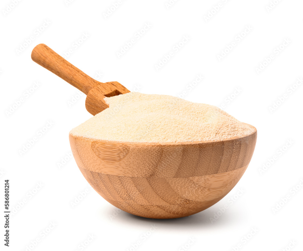 Bowl of raw semolina on white background