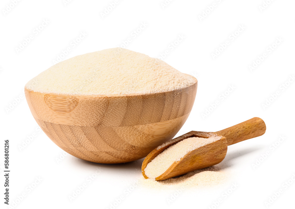 Bowl and scoop with raw semolina on white background