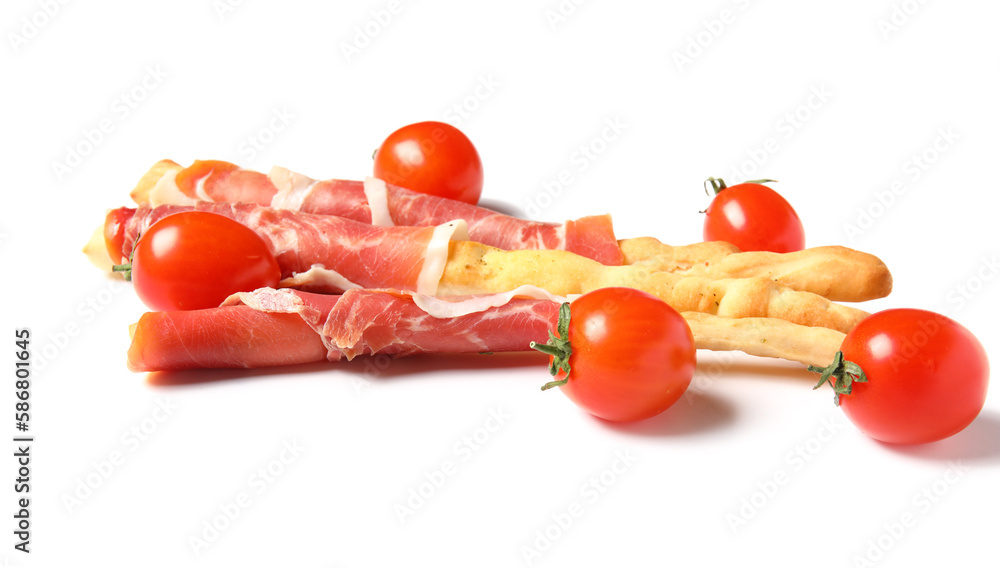 Tasty Italian Grissini with bacon and tomatoes on white background