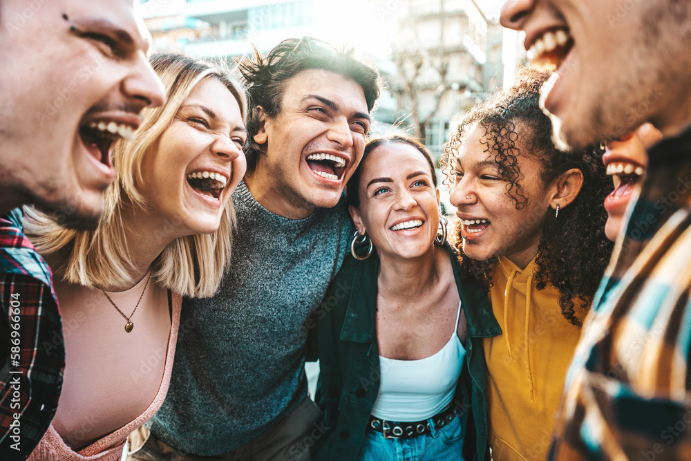 Multiracial happy friends laughing walking outside - Cheerful young people having fun hanging out on