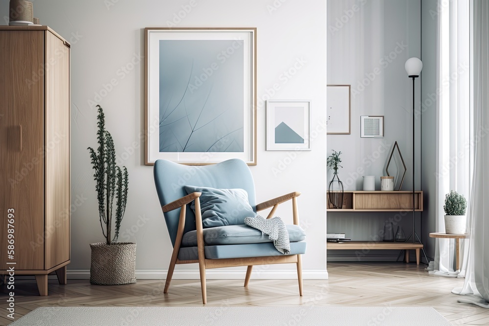 Interior of a white living room with a blue armchair, a vertical poster in a frame, and some drawers