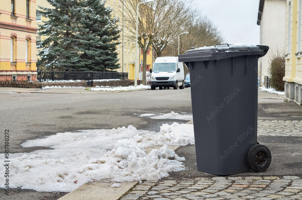 View of garbage container in city on winter day