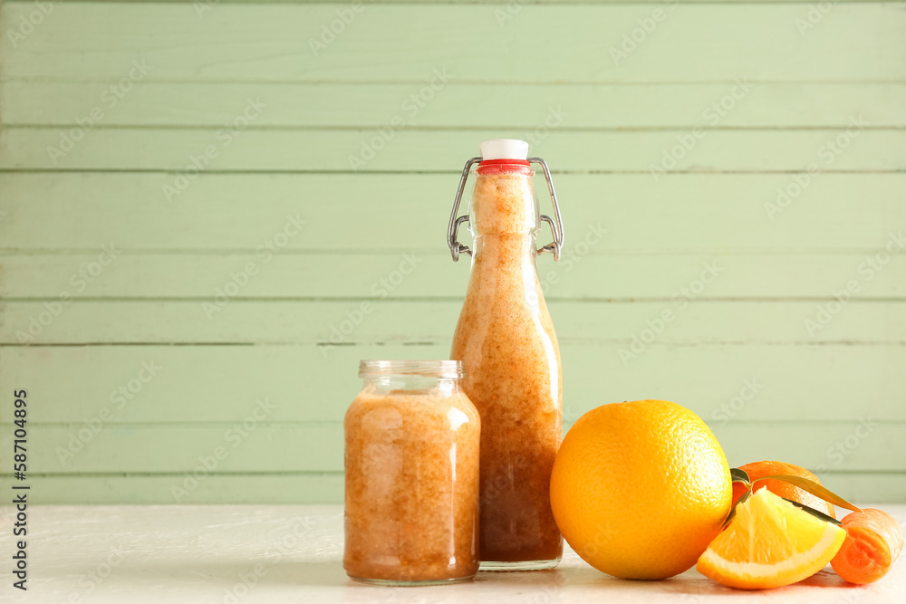 Bottle and jar of healthy smoothie with ingredients on table